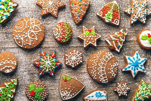 Christmas gingerbread cookies on wooden table with sugar