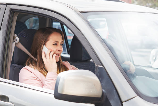 istock Smiling woman driver chatting on smartphone 878880042