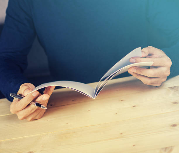istock Vintage filtered read book on wooden desk 878885174