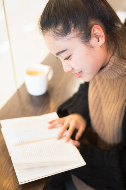 istock woman reading in cafe 878888070