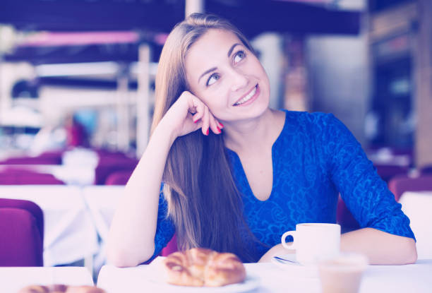 istock Young woman is dreaming in time breakfast 878897368