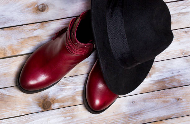 istock Leather woman boots on wooden background 878900892