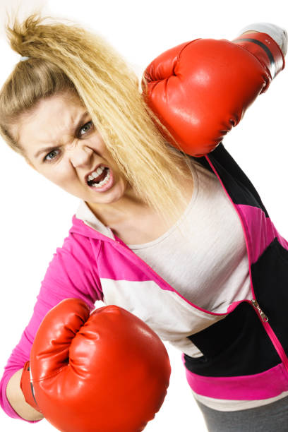 istock Angry woman wearing boxing gloves 878902310