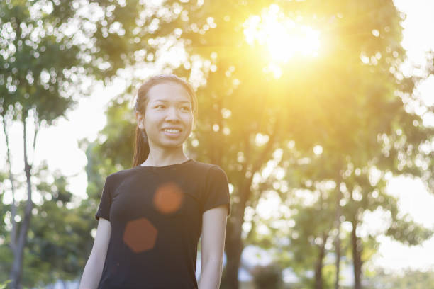 istock Happy Asian woman in park 878918410