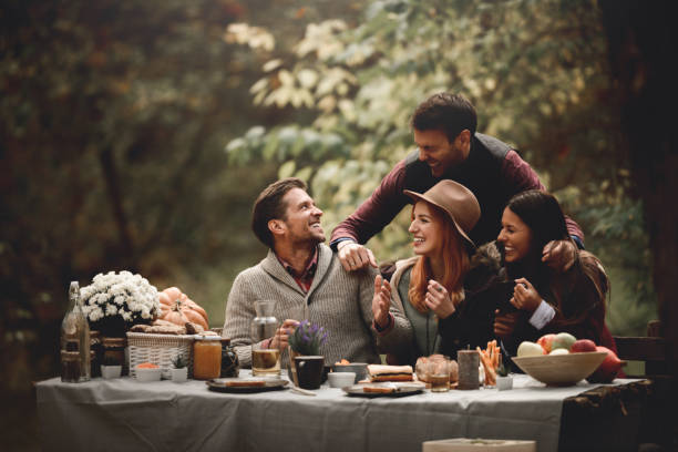 It's picnic time Friends enjoying time together in the park. fall picnic table stock pictures, royalty-free photos & images