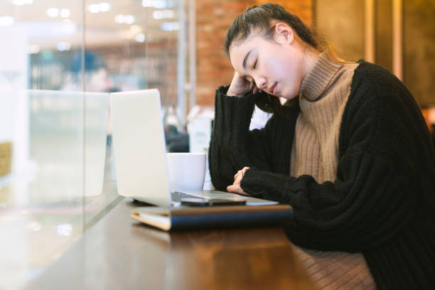 istock woman working on laptop and looking tired 878931792