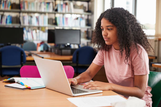 istock Female Student Working At Laptop In College Library 878934470