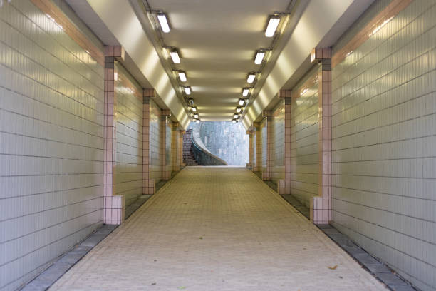 istock quiet underground tunnel walkway singapore city. this image for architecture concept 878934574