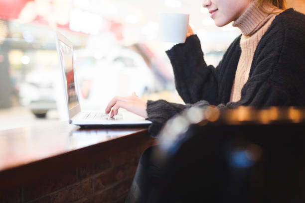 istock woman having a coffee and using laptop in cafe 878934800