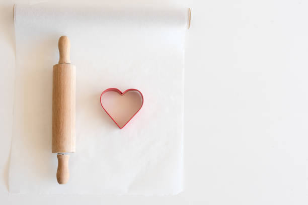 istock Heart shaped cookie cutter and rolling pin from above 878935284
