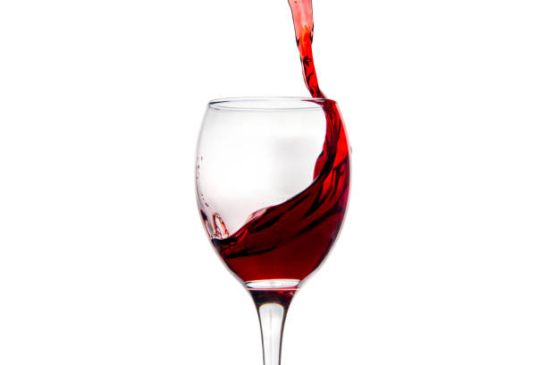 istock Wineglass with splashing drops of red wine 878935492
