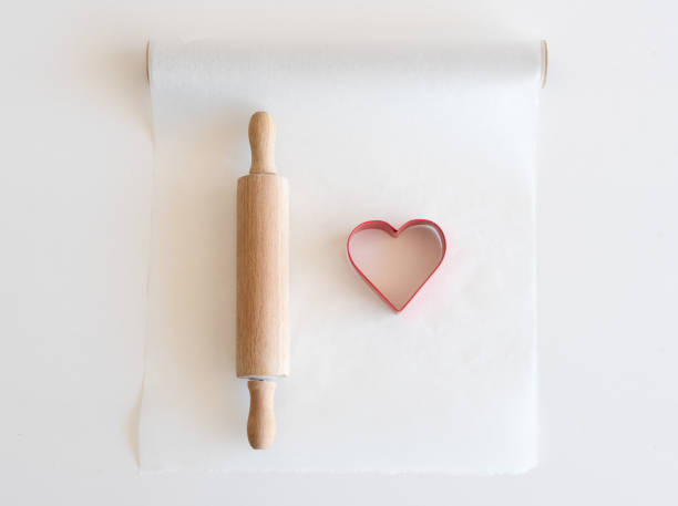 istock Heart shaped cookie cutter and rolling pin from above 878935606