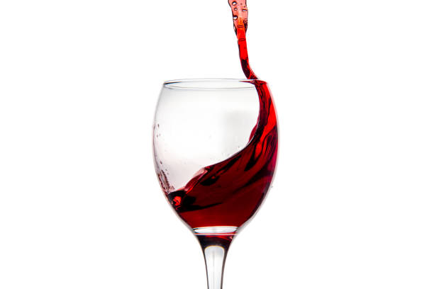 istock Wineglass with splashing drops of red wine 878938906