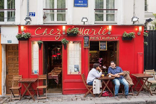 Paris, France - September 09, 2017: People sit in front of a small french restaurants.