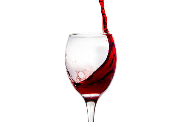 istock Wineglass with splashing drops of red wine 878938932