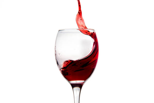 istock Wineglass with splashing drops of red wine 878938964