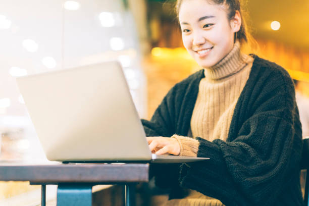 istock woman using laptop in cafe 878939328