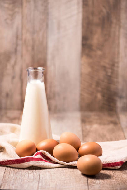 istock Eggs and milk on wooden background. Copy-space 878952812