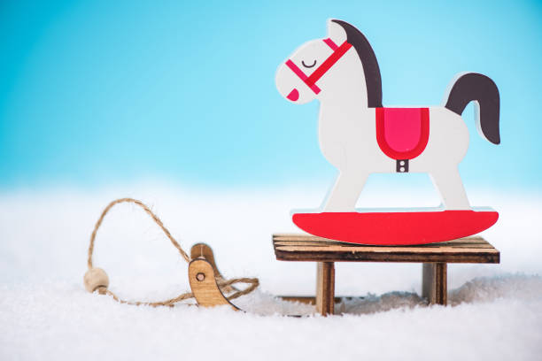 istock Wooden rocking horse on snow sledge 878953804