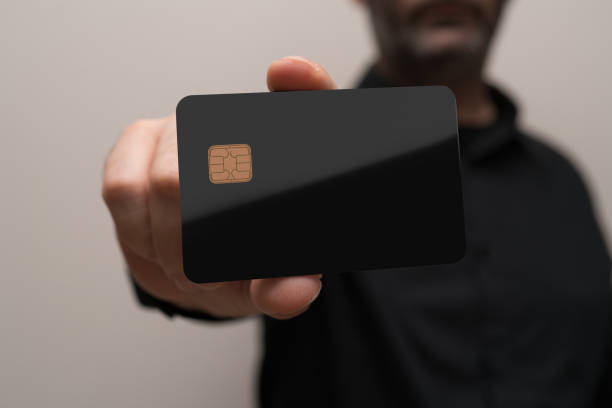istock man holding a blank credit card in hands 878960900
