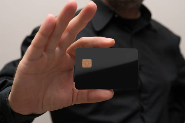 istock man holding a blank credit card in hands 878960904