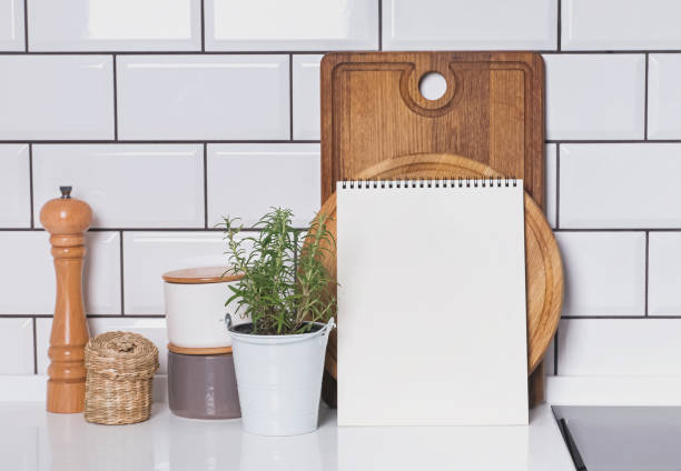 istock Blank paper mock-up in modern kitchen interior with white tile brick wall and wooden boards 878961736