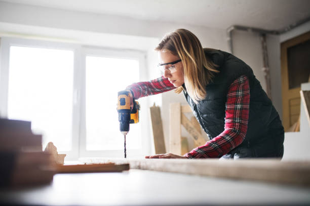 istock Young woman worker in the carpenter workroom. 878962070