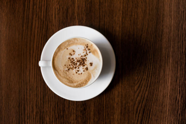 istock White coffee cup on wooden desk table 878964520