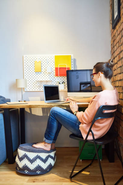 istock Young girl performing university tasks, sitting at home at the computer 878964522