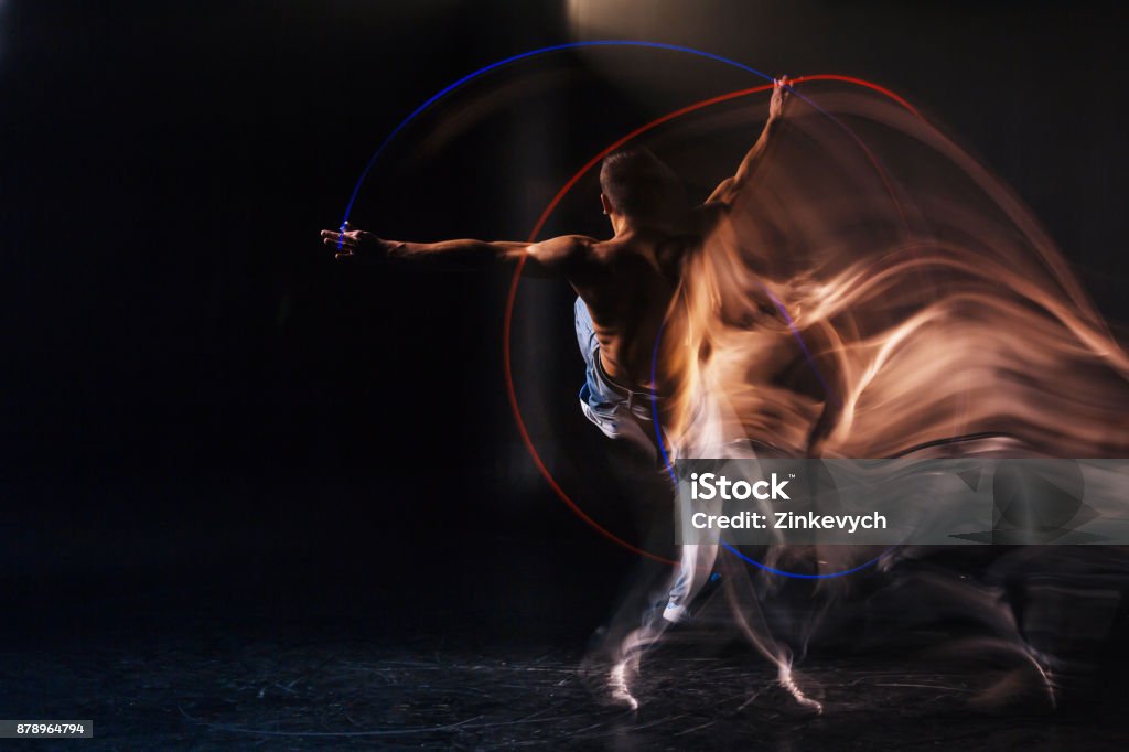 Nice handsome man being focused on the dance bsolutely serious. Nice pleasant handsome man practicing his movements and being focused on the dance while performing on stage Dancing Stock Photo