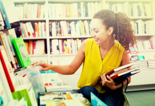 istock Young woman in book shop 878969700