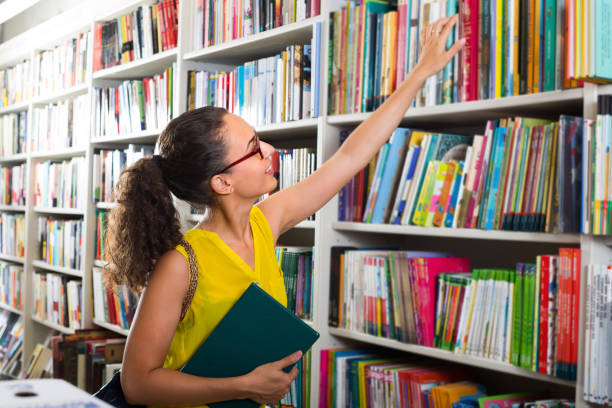 istock young woman in book shop 878969718
