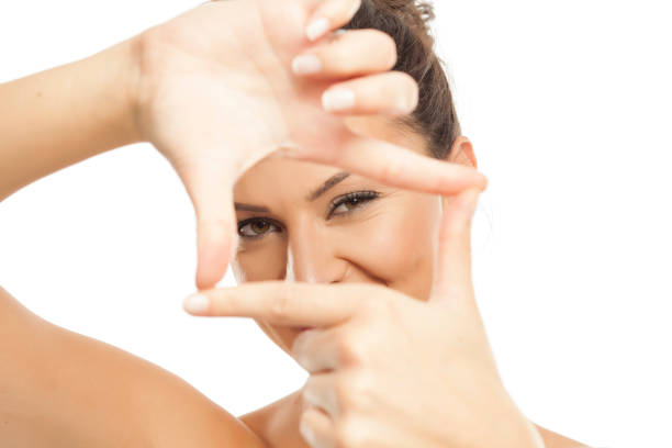 istock A young woman making a frame with her fingers 878981046