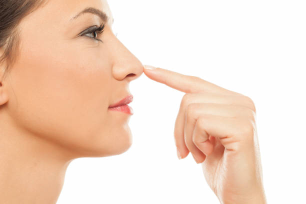 istock Young woman touching her nose with her finger 878981098