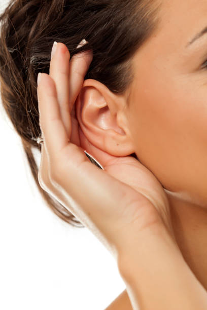 istock palm behind ear. concept to listen 878981168