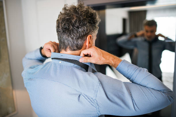 istock Mature businessman in a hotel room. 878981694