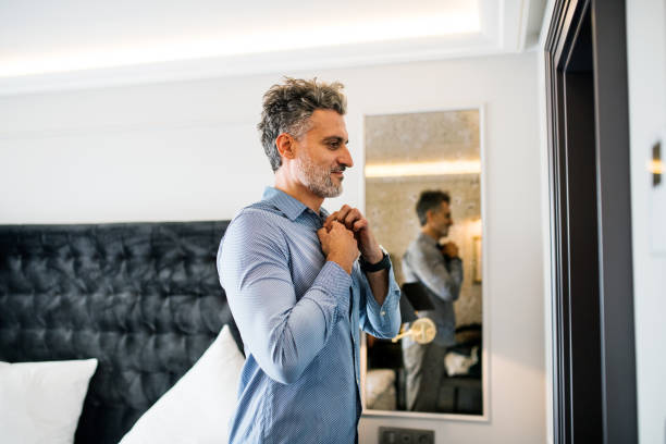 istock Mature businessman in a hotel room. 878990486