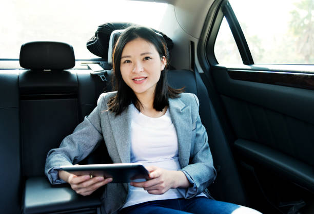 istock Businesswoman using digital tablet in car 878993572