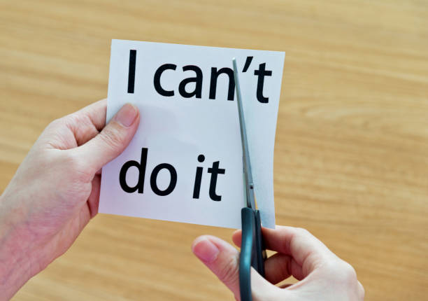 istock Human hand cutting word on paper can't become i can 878994890