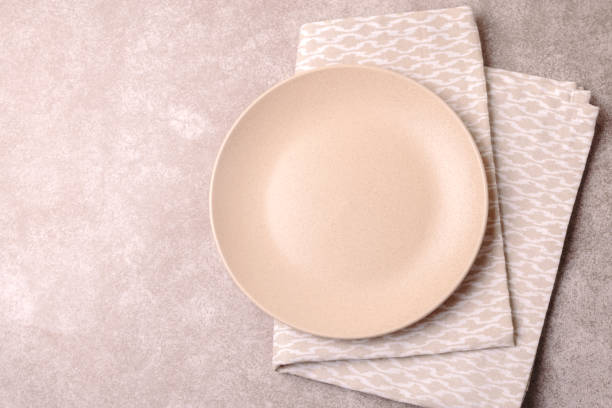 istock Empty vintage ceramic plate, cutlery, napkin. Top view, copyspace. 879008422