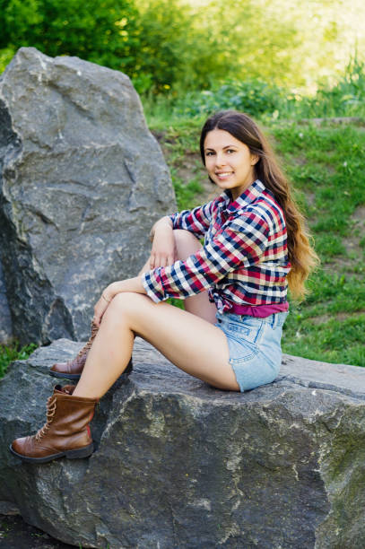 istock Girl on a big stone in the park 879008566