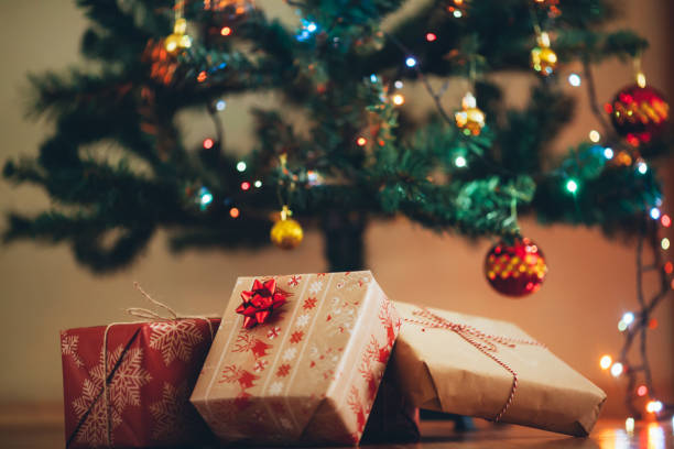 istock Christmas tree and holidays present on wooden flat 879008636