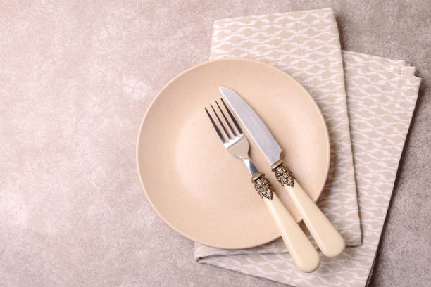 istock Empty vintage ceramic plate, cutlery, napkin. Top view, copyspace. 879008718