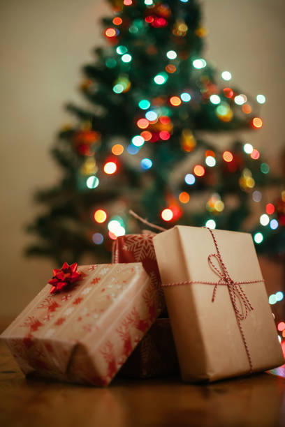 istock Christmas tree and holidays present on wooden flat 879009180