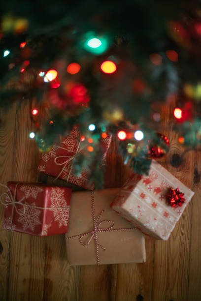 istock Christmas tree and holidays present on wooden flat 879010698