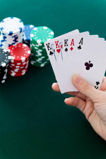 istock Woman hand holding aces and king cards 879012074