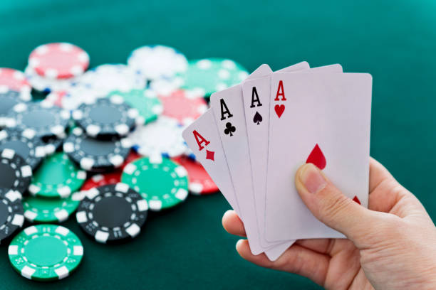istock Woman hand holding four aces 879012326