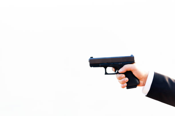 istock Gun with Businessman hand 879015522