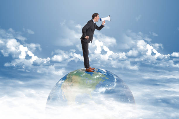 istock Businessman making global announcement using megaphone 879016592