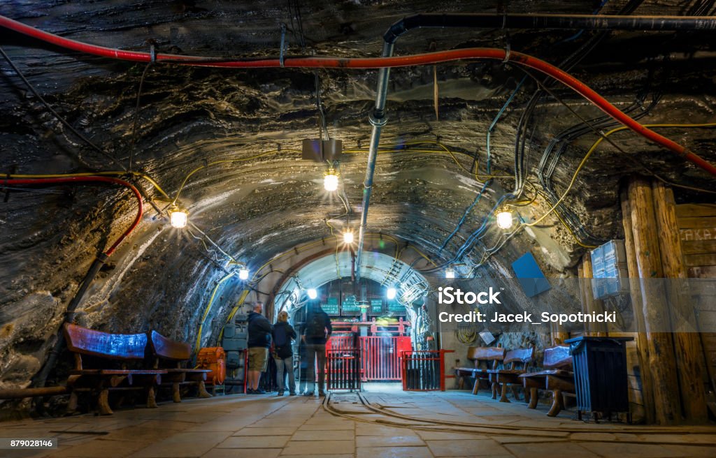 A few tourist waiting underground in the mine for the elevator A few tourist waiting underground for the elevator, Bochnia salt mine, Poland Mining - Natural Resources Stock Photo